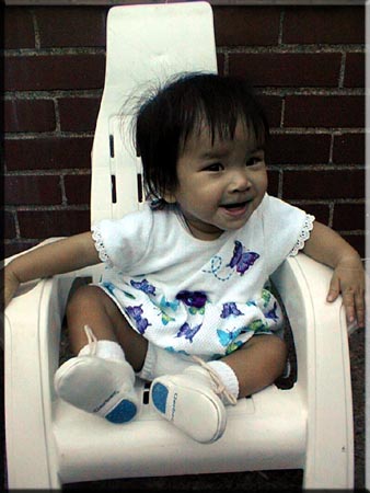 Likes her chair. June 30, 2001