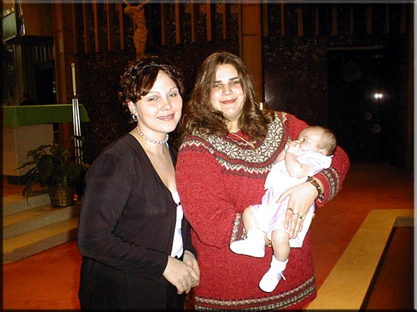 Tara and Nicole getting Brayden baptized.